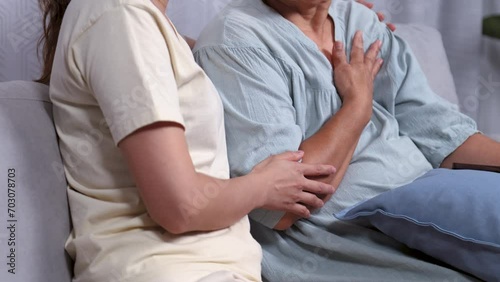 Asian caregiver nurse female takes care elderly patient woman during a chemotherapy cancer session, senior sickness retired mother and daughter worried stress and pain with negative symptoms occurred photo