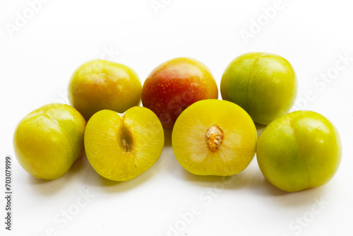 Fresh green plum fruit on white background.