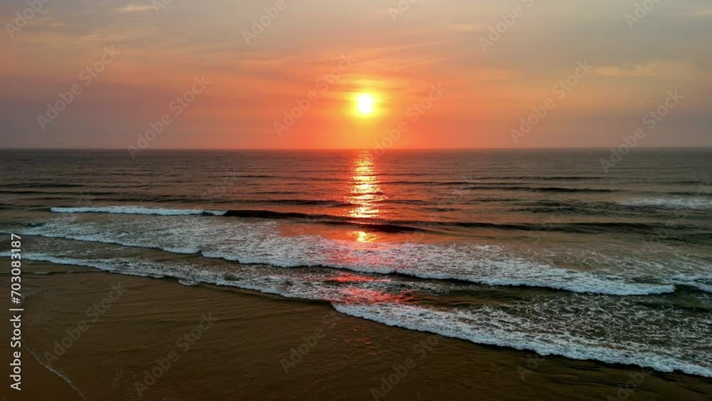 Captivating Sunset Over Serene Ocean Waves: A Tranquil Display of Warm Hues and Gentle Tides