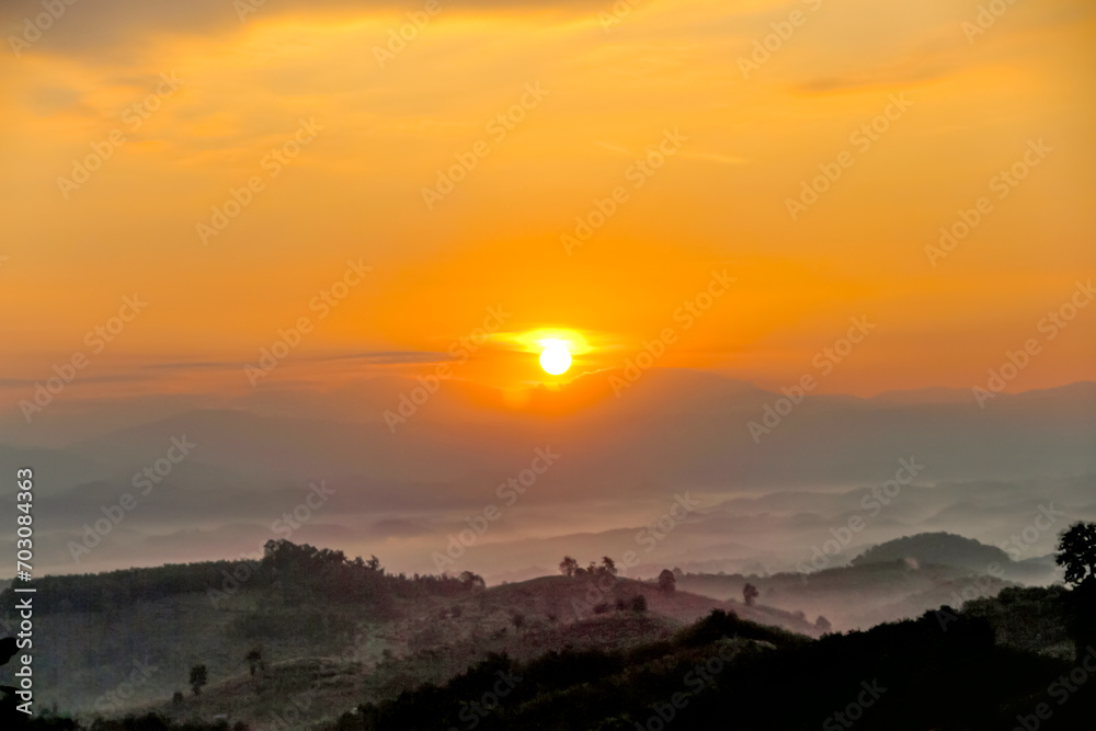 Sunrise on beautiful orange sky on landscape of mountains dawn background