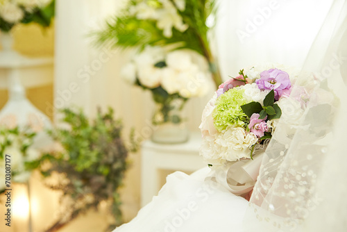 Wedding bouquet in the hands of a bride in a wedding dress 