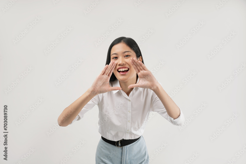 A cheerful young Asian woman makes a A cheerful young Asian woman makes a