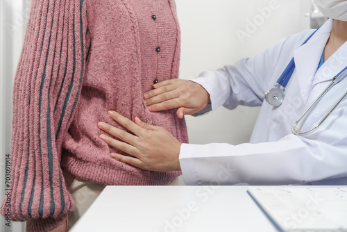 female medical professional with a stethoscope is holding a clipboard, possibly discussing gastritis or other stomach diseases with a patient.