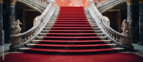 Red carpet covering marble stairs.