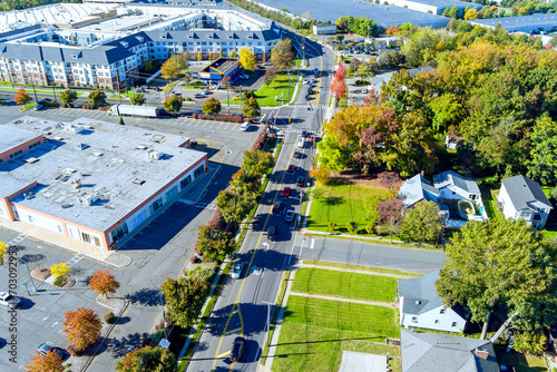 Fototapeta Naklejka Na Ścianę i Meble -  In New Jersey, United States, a view from an aerial perspective of beautiful small American town near road with cars