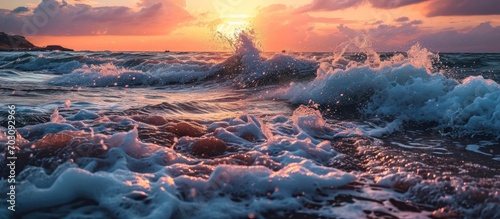 Stunning colorful sunset sea with foamy splashes.