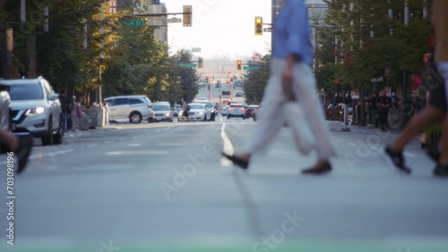 Pedestrians and bicycles crossing the busy street in downtown Vancouver. Slow motion. 