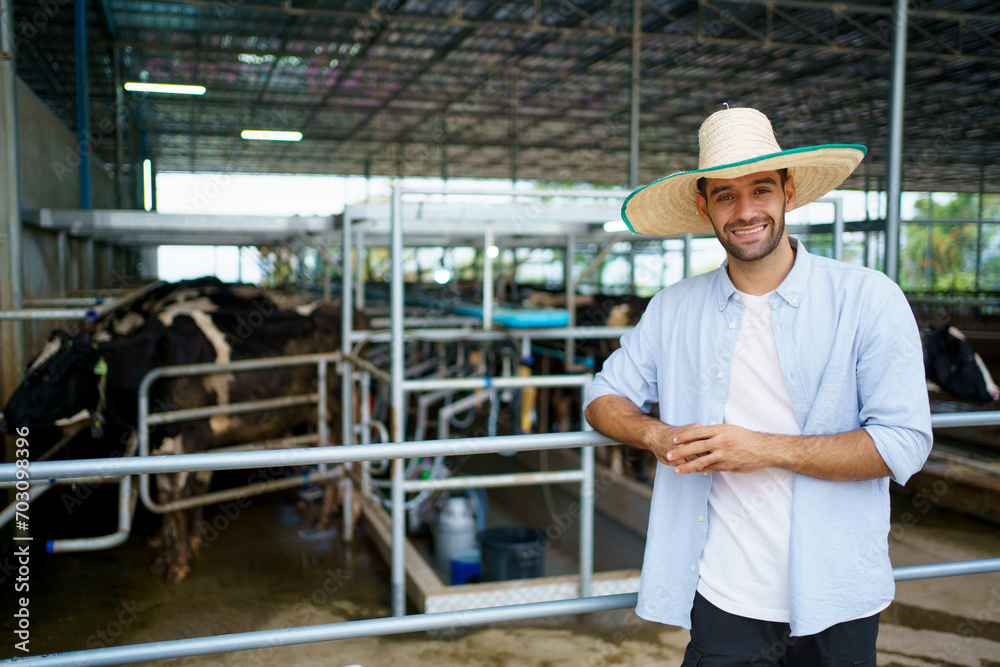 Portrait of cow milk agricultural farmer standing beside of the animal shelter in the farm. Livestock business owner portrait.