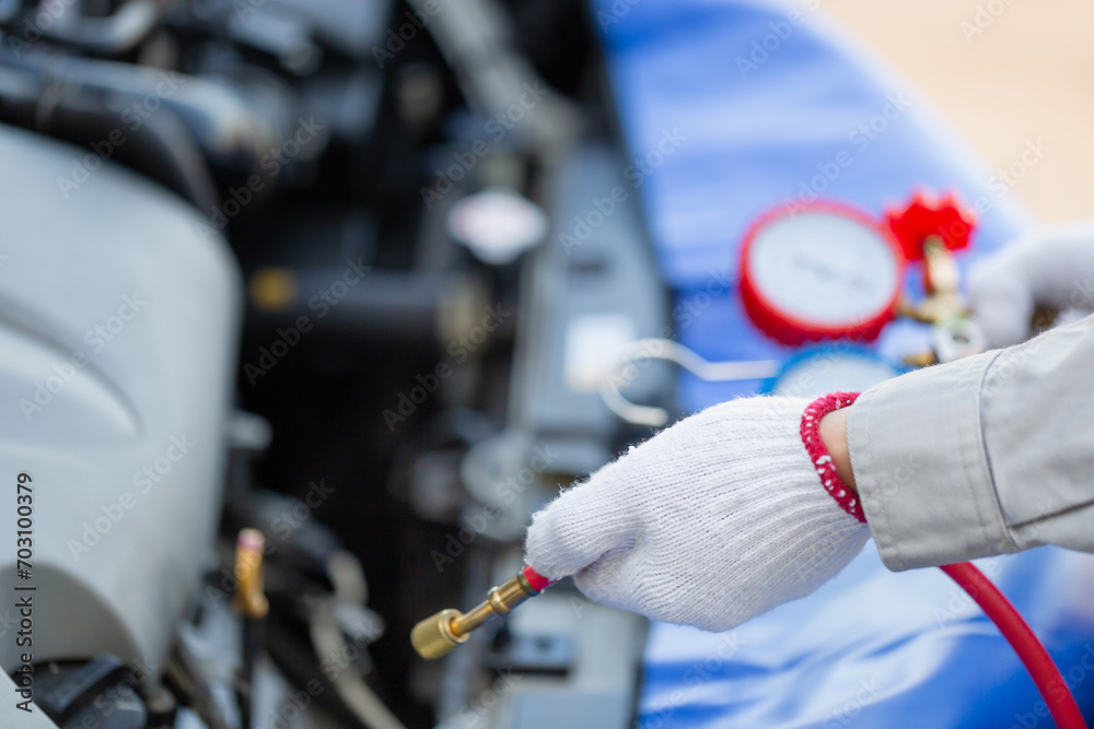 Naklejka premium Repairman holding monitor tool to check and fix car air conditioner system, Technician check car air conditioning system refrigerant recharge, Car Air Conditioning Repair