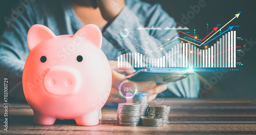 Businessmen use internet technology to analyze data graphs for financial planning. The goal is to invest wisely and save money for future expenses. piggy bank saving concept for financial stability. photo
