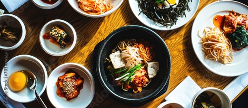 Bird's-eye view of Pyebaek Food with toppings and dried fruits on plate, South Korea. photo