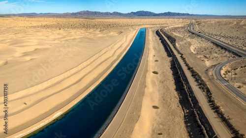 Dramatic aerial view of the all-American canal traveling through the Buttercup sand dunes in imperial county California.