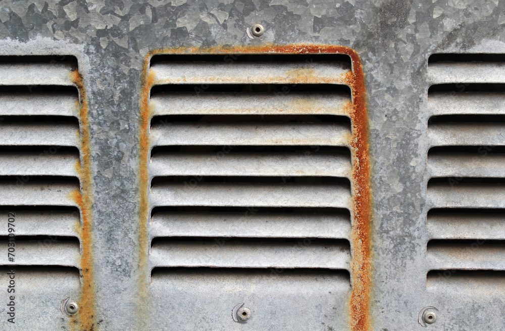 Rusty air vents on a steel textured background Rusty air vents on a steel textured background