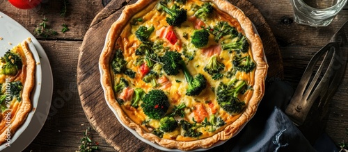 Top view of a savory quiche pie with salmon, broccoli and a delicious taste.