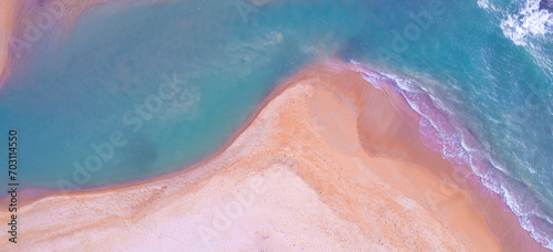 Aerial view of the beach and water on the island. During the summer the sun hits the sandy beach. Sparkling sea water. For a summer vacation idea. 