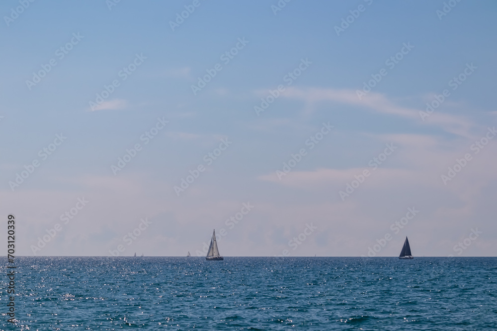Majestic sailing boats gracefully glides through the crystal clear waters of the Gulf of Piran, located along the captivating Slovenian coastline of the Adriatic Mediterranean Sea. Summer vacation