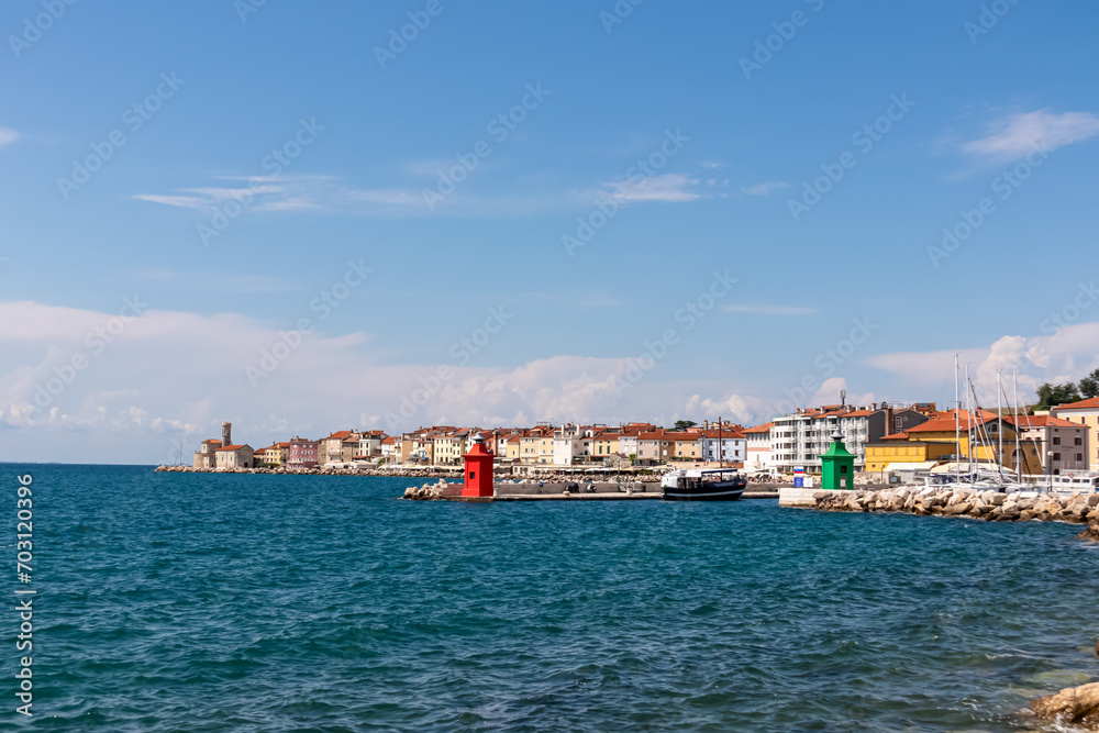 Enchanting beauty of Piran, a charming coastal town nestled in Gulf of Piran. Seen from picturesque Portoroz in Slovenia. Enjoying tranquility and serenity of coastal walkway along Slovenian coastline