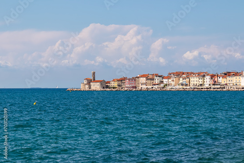 Enchanting beauty of Piran, a charming coastal town nestled in Gulf of Piran. Seen from picturesque Portoroz in Slovenia. Enjoying tranquility and serenity of coastal walkway along Slovenian coastline