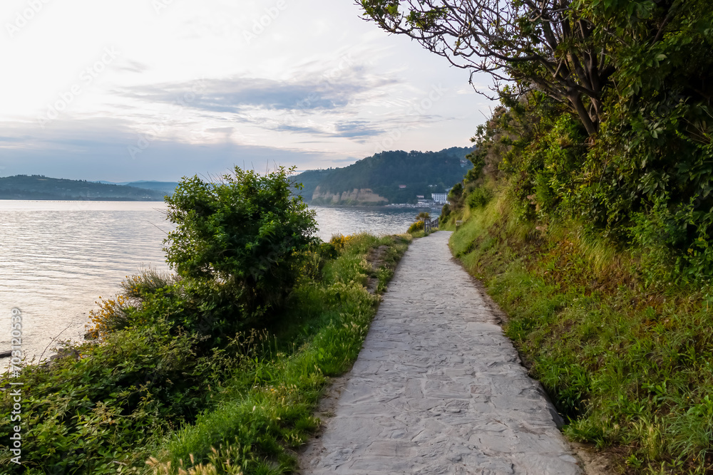 Scenic walking path between Fiesa and charming coastal town of Piran in Slovenian Istria, Slovenia, Europe. Rugged rocky cliffs gracefully perched above shimmering waters of the Adriatic Sea. Seascape