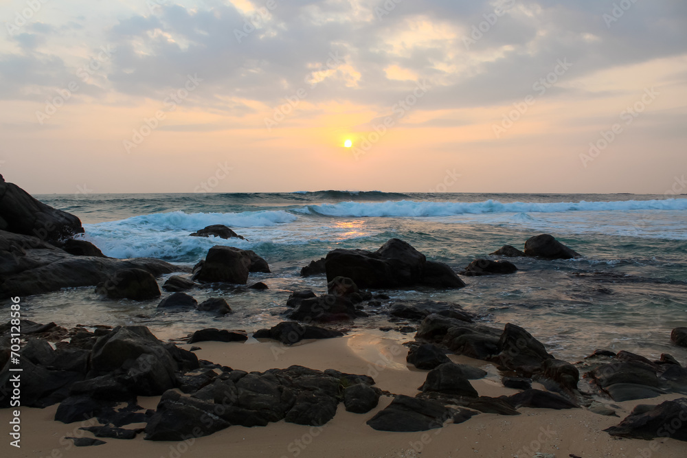 The sun setting into the sea at Delawella beach, Sri Lanka. Golden light The sun setting into the sea at Delawella beach, Sri Lanka. Golden light