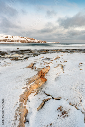 A freezing cold winter day by the sea during the polar night, Varanger Peninsula; Northern Norway photo