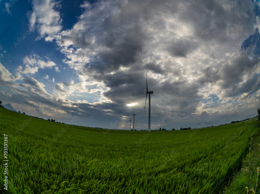 Φωτογραφία Close-up of a wind turbine producing electricity in the middle of a field and Ph