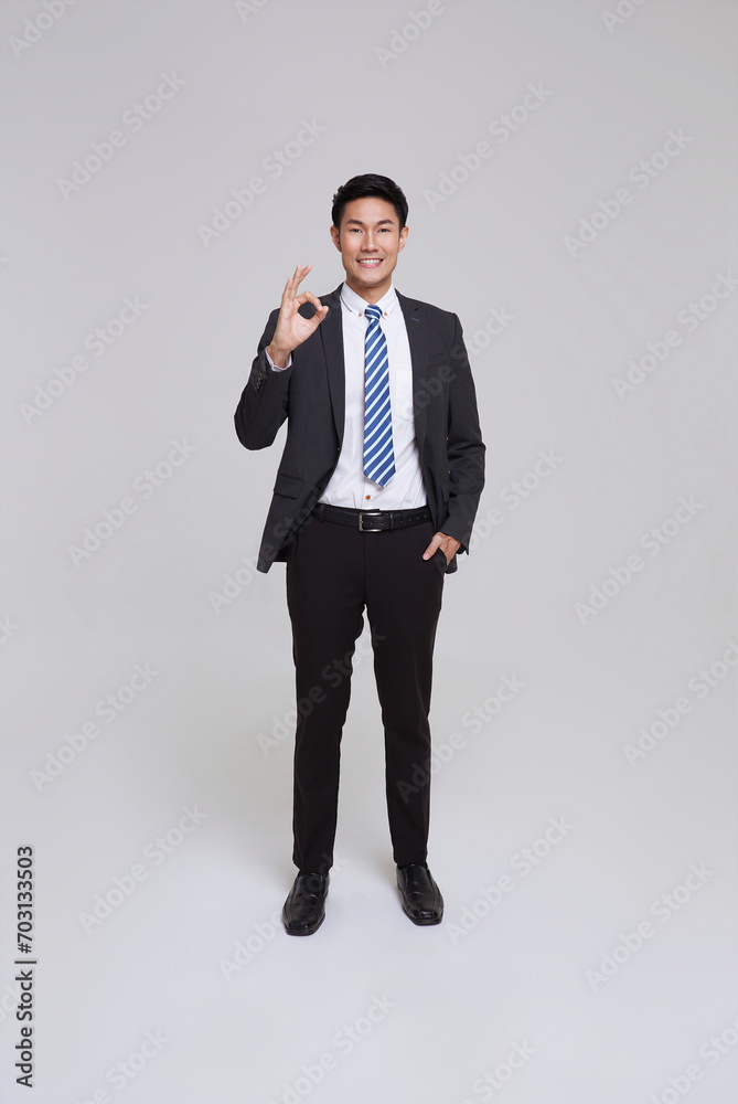 asian business people man good looking in studio. portrait businessman in grey suit confident show okay gesture, approve plan isolated on white background. asian business people man good looking in studio. portrait businessman in grey suit confident show okay gesture, approve plan isolated on white background.