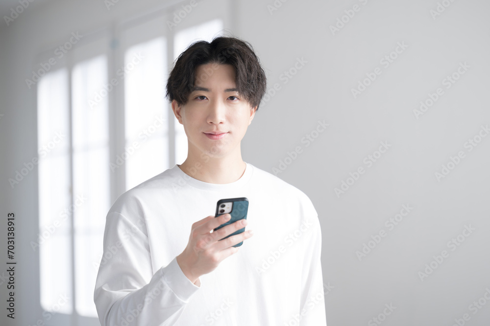 Handsome man looking at phone close-up Looking at camera Handsome man looking at phone close-up Looking at camera