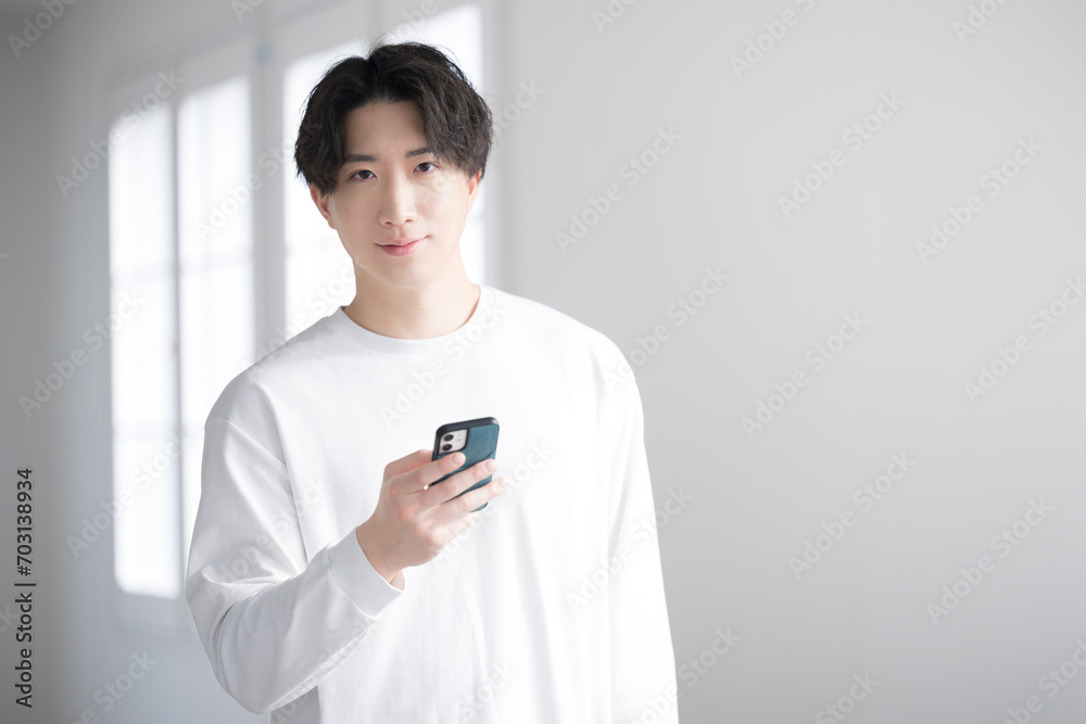 Handsome man looking at phone close-up Looking at camera Handsome man looking at phone close-up Looking at camera