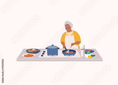 One Smiling Black Senior Woman With Apron Cooking Dinner With Frying Pan On Top Of Kitchen Stove. Half Length.