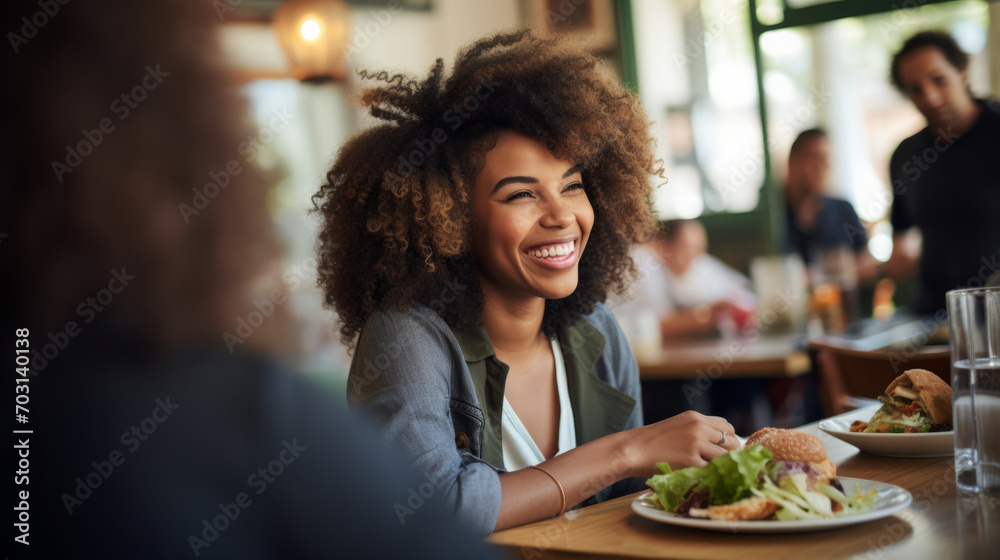 Black afro American business woman having a friendly lunch with colleagues at a local cafe, she engages in casual conversation, fostering a positive and collaborative atmosphere Black afro American business woman having a friendly lunch with colleagues at a local cafe, she engages in casual conversation, fostering a positive and collaborative atmosphere