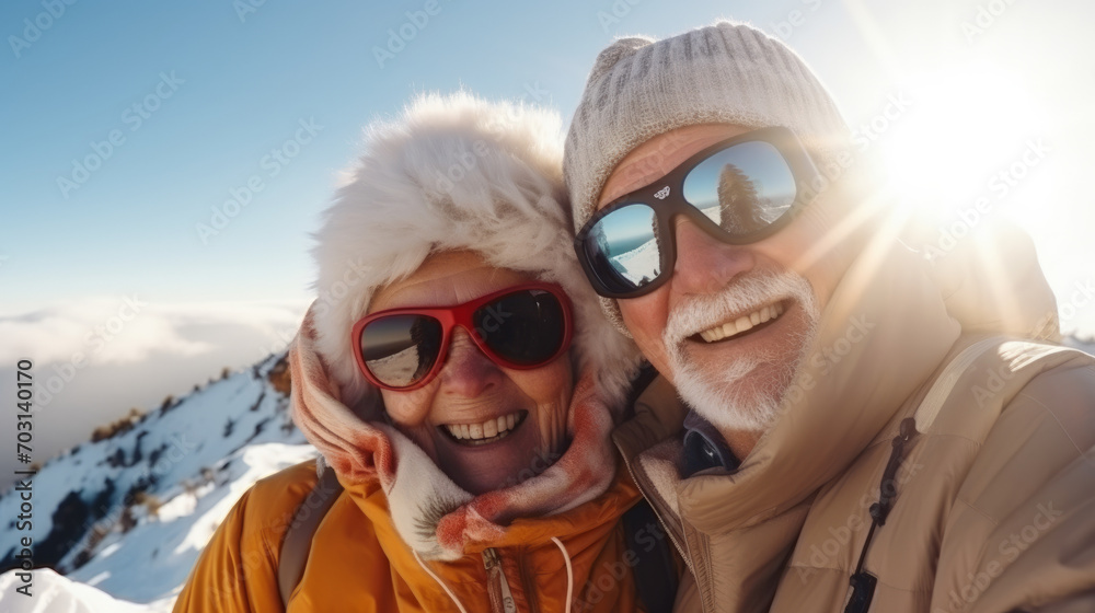 Portrait of old elderly couple at top of snowy mountain for winter sports holidays Portrait of old elderly couple at top of snowy mountain for winter sports holidays
