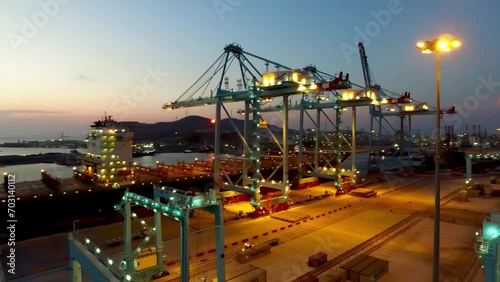 night drone view of giant cranes in the port