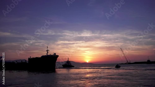 drone view of cargo ships waiting at sunset