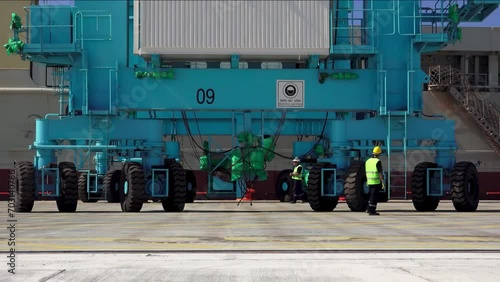 Workers working next to containers in the port