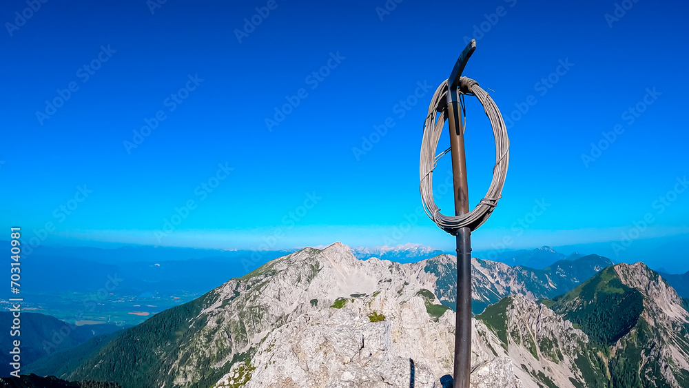 Mountain summit of Vertatscha (Vrtaca) with scenic view of majestic Hochstuhl (Stol) in untamed Karawanks, border Slovenia Austria. Looking at mountain ranges of Julian Alps. Wanderlust Slovenian Alps