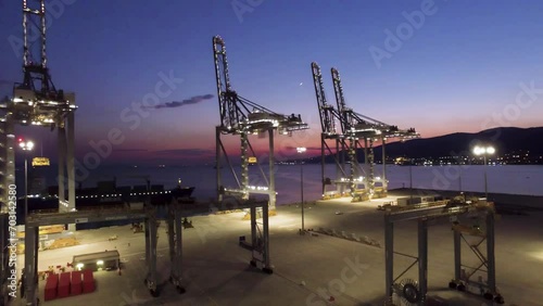Drone view of giant cranes in the harbor at sunset