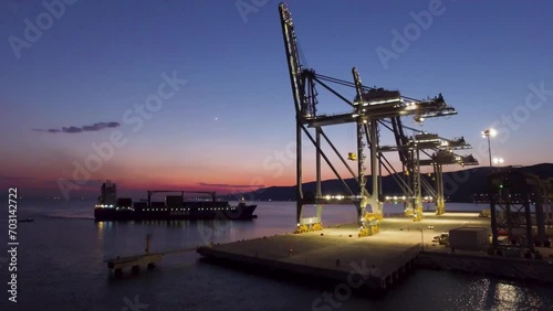 Drone view of giant cranes in the harbor at sunset