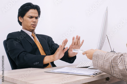 Foto Young lawyer or politician showing stop gesture to refusing money from business people