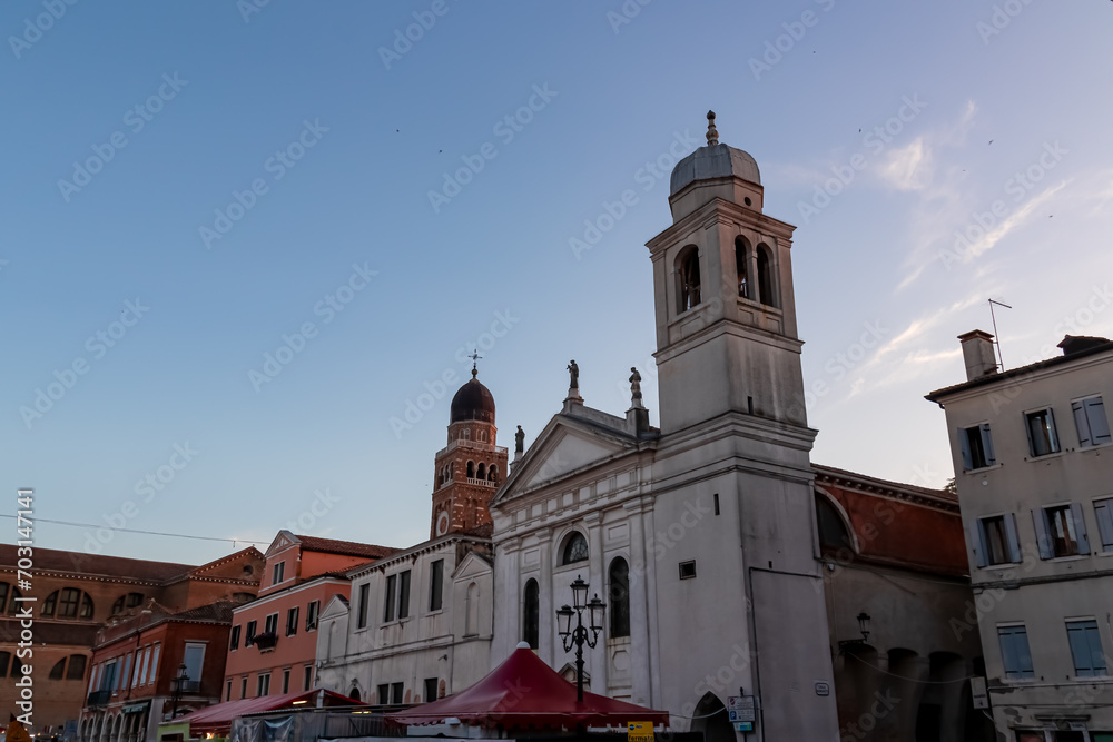 Fototapeta premium Close up view of majestic church Chiesa di San Francesco in old town of Chioggia, Venetian Lagoon, Veneto, Italy. Tranquil sunset atmosphere in summer. Historical landmark with Venetian architecture