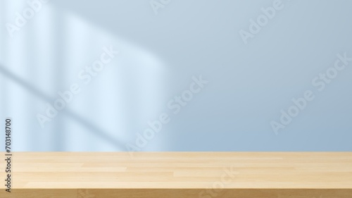 Empty space wooden table top on blue wall background with window sunlight. Mockup scene display for products presentation. 