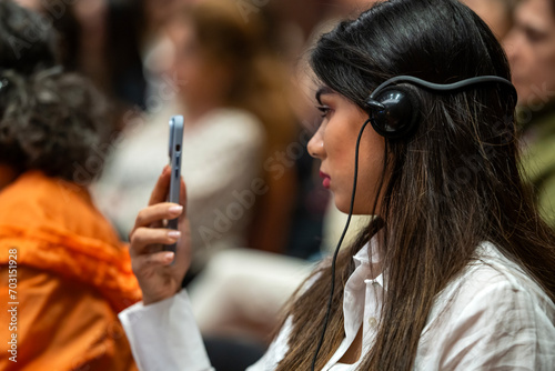 a set of headphones for simultaneous translation during negotiations in foreign languages. woman headphones used for simultaneous translation equipment simultaneous interpretation 