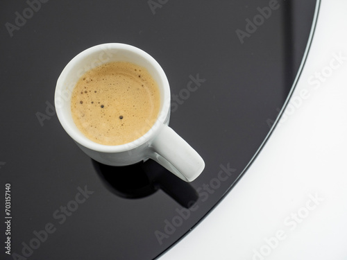 cup of coffee on the black glass table