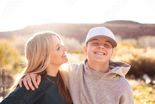 Mother being playful with her cute teenage son. Having a happy moment together. Concept photo about parenting tough teenage children. Candid photo