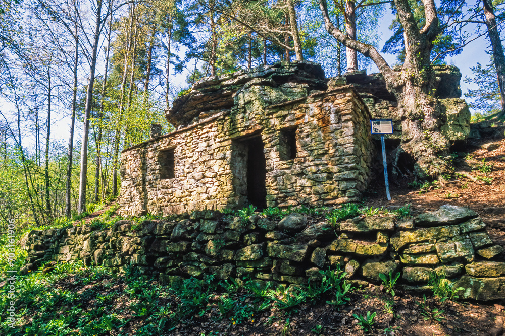 Old stone house by a rock in the forest at spring at kinnekulle in sweden