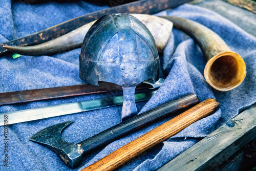 Sword and ax by a helmet from the Middle Ages photo