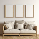 Room with three blank frames mockup on the wall and a beige sofa with pillows
