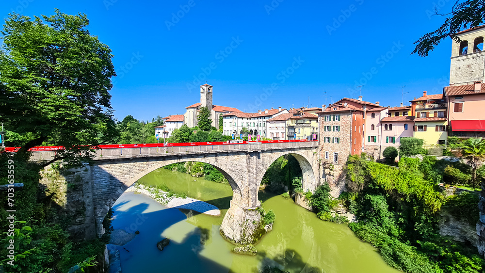 Scenic view of bridge Ponte del Diavolo in town of Cividale del Friuli, Udine province, Friuli Venezia Giulia, Italy. Idyllic atmosphere along banks of serene Natisone river. UNESCO World Heritage
