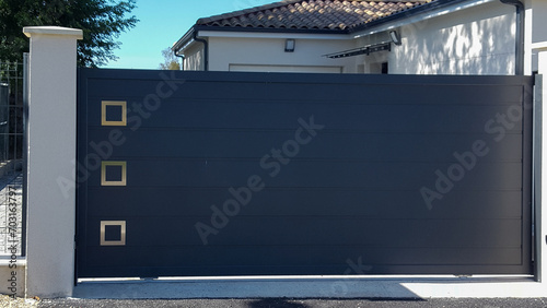 grey steel modern gate aluminum facade portal of home door of suburbs house entrance in street view photo