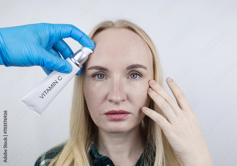 Vitamin A, Retinol, Niacinamide, Vitamin C. Girl smears her face with